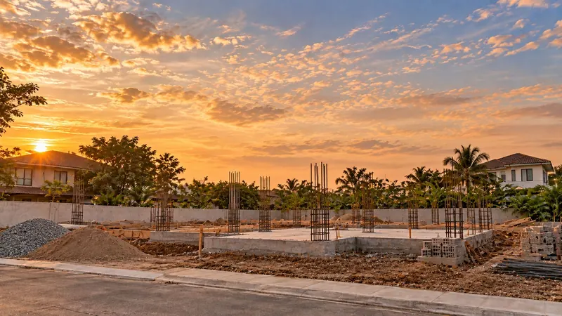 Illustrative render: concrete footings with steel reinforcement bars rising from them